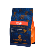 Angled view of Copper Door Coffee Roasters Brazil coffee beans with tasting notes of Red Apple, Nuts, and Chamomile 
