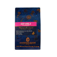 A bag of Guatemala coffee beans from the Huehuetenango region with tasting notes of fig newtons, cocoa nibs, and almonds.