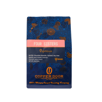 A front view of a bag of Four Sisters espresso coffee beans with notes of chocolate ganache, caramel, and key lime from Copper Door Coffee Roasters.