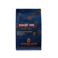 A bag of Midnight Mama coffee beans with tasting notes of tobacco, dark chocolate, and walnut from Copper Door Coffee Roaster's. 