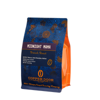 A bag of Midnight Mama coffee beans with tasting notes of tobacco, dark chocolate, and walnut from Copper Door Coffee Roaster's. 