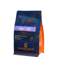 Angled view of Shady Lady Coffee Blend with tasting notes of Mixed Berry, Lemon Zest, and Black Cherry.